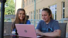 Students studying out on the Le Fer porch